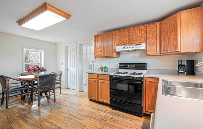 Eat-in kitchen with wood floors | Image 16