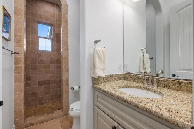 Full bathroom featuring vanity, tiled shower, and tile patterned floors | Image 23