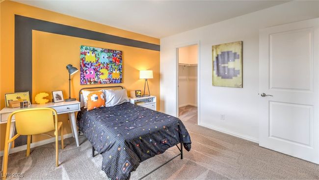 Photo is representational only; actual home finishes may vary. Bedroom featuring carpet flooring, a walk in closet, baseboards, and a closet | Image 12
