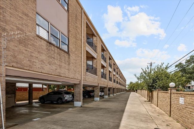 View of building exterior with covered parking | Image 37