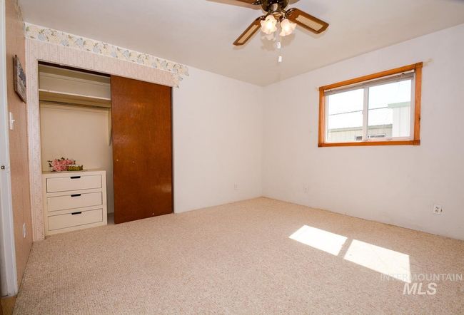 Unfurnished bedroom with carpet flooring, a closet, and ceiling fan | Image 22