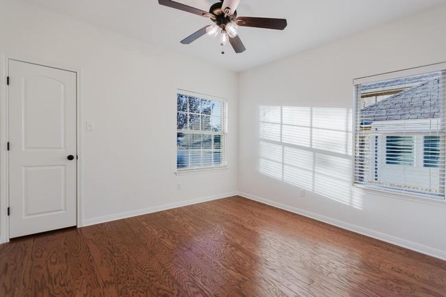 Empty room featuring vaulted ceiling, a ceiling fan, baseboards, and wood finished floors | Image 14