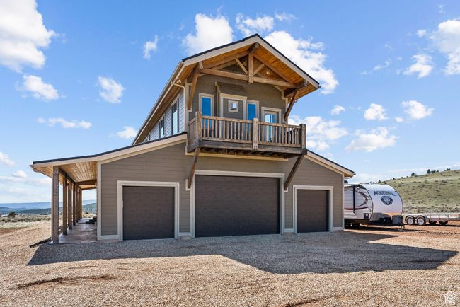 View of front of home with dirt driveway and a balcony | Image 16
