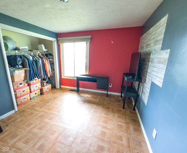 bedroom featuring baseboards, a closet, and a textured ceiling | Image 8