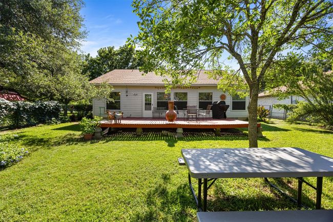 Rear view of house with a deck and roof with shingles | Image 28