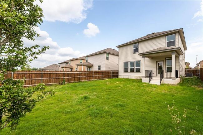 Rear view of house with a fenced backyard | Image 5