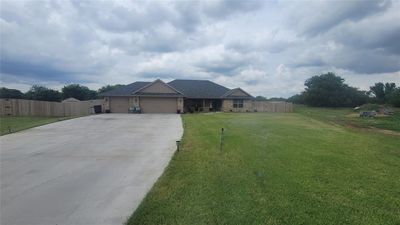 View of front of house featuring a garage and a front yard | Image 2