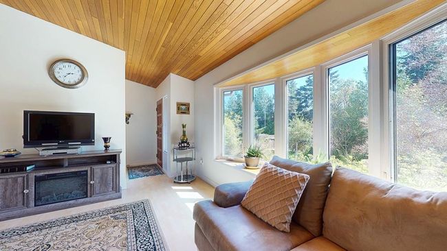 Living room with vaulted wood ceiling, and a healthy amount of sunlight | Image 10