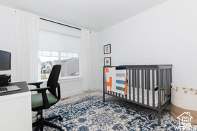 Bedroom featuring a desk and a crib | Image 11