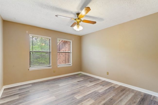 2nd bedroom with ceiling fan, plank floors | Image 12