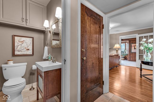 bathroom featuring vanity, toilet, ornamental molding, baseboards, and wood finished floors | Image 16