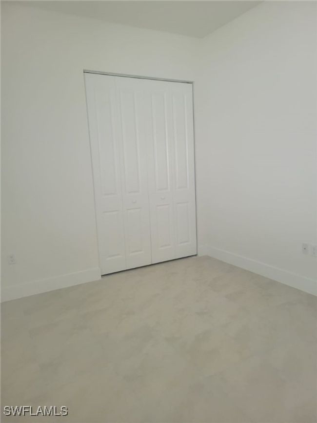 Unfurnished bedroom with baseboards and a closet | Image 23