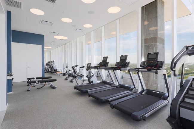 Gym featuring expansive windows, top of the line gym equipment and vies of West Austin/ Lady Bird Lake | Image 17
