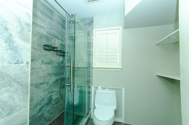 Full bathroom with toilet and a shower stall | Image 15