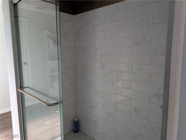 Full bathroom with tiled shower and wood finished floors | Image 14