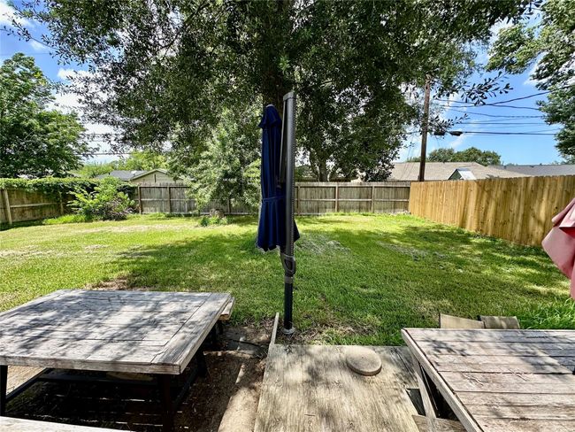Enjoy the shade from the tree while lounging in the fenced backyard. | Image 22
