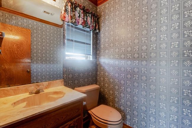 This half bath is conveniently located off of the gameroom. Perfect for entertaining! | Image 19