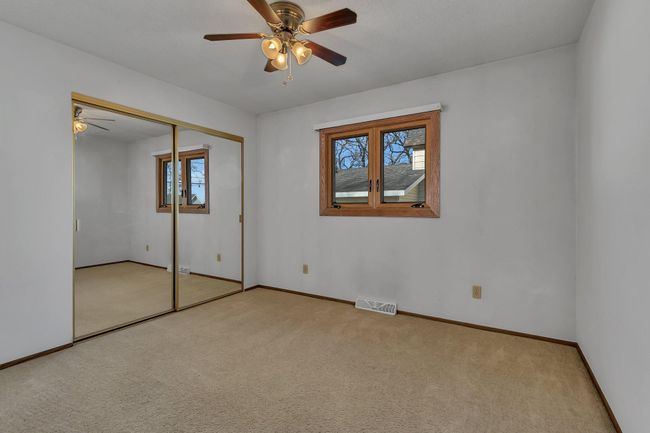 2nd bedroom on main level with ceiling fan | Image 17