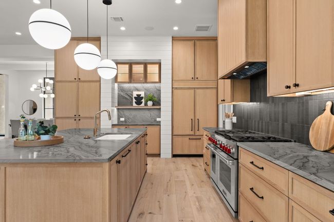 This kitchen is equipped with a Sub-Zero built-in refrigerator and 6-burner stove and double oven. | Image 11
