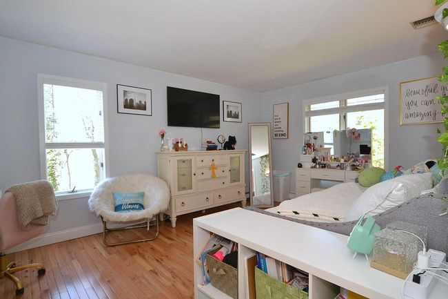 Bedroom with visible vents and light wood-style floors | Image 14
