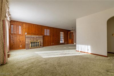 Living room with large window and fireplace. | Image 3