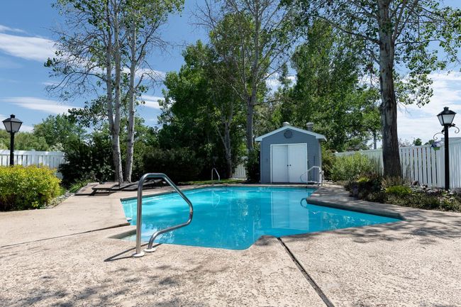 View of pool featuring a patio and a storage unit | Image 14