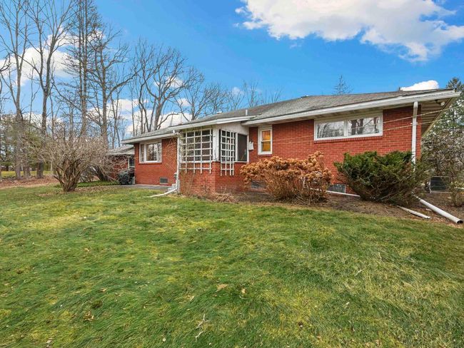 Rear view of house with a yard | Image 35