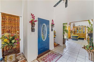 Foyer entrance with a high ceiling, ceiling fan, and light tile patterned floors | Image 3