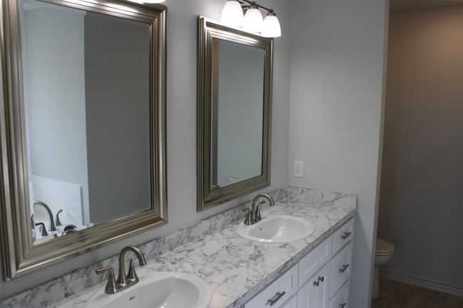 Bathroom with double vanity and toilet | Image 9