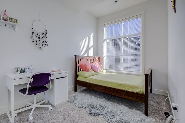 Bedroom featuring light colored carpet and a desk | Image 12
