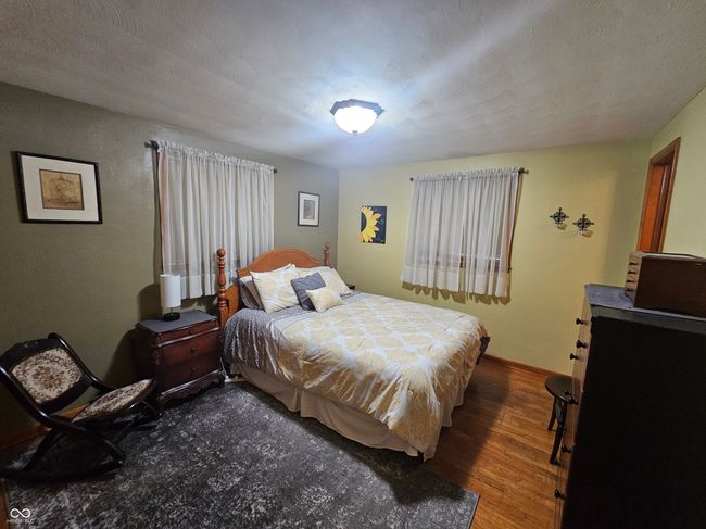 bedroom featuring wood finished floors and baseboards | Image 18