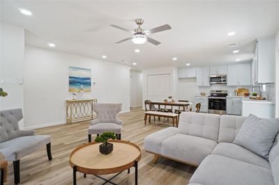 Living room with ceiling fan and light hardwood / wood-style flooring | Image 2