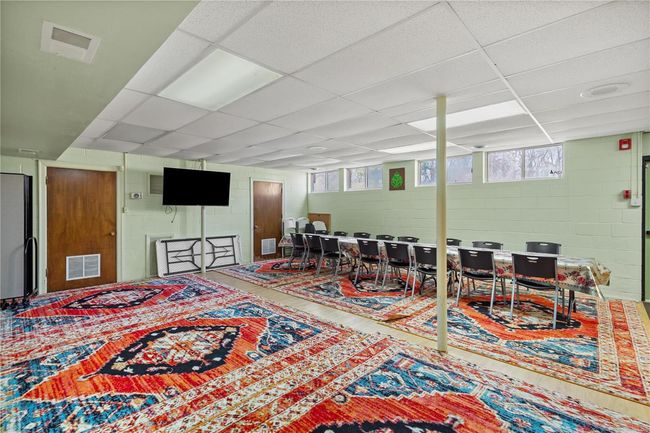 Playroom featuring visible vents, concrete block wall, and a drop ceiling | Image 16