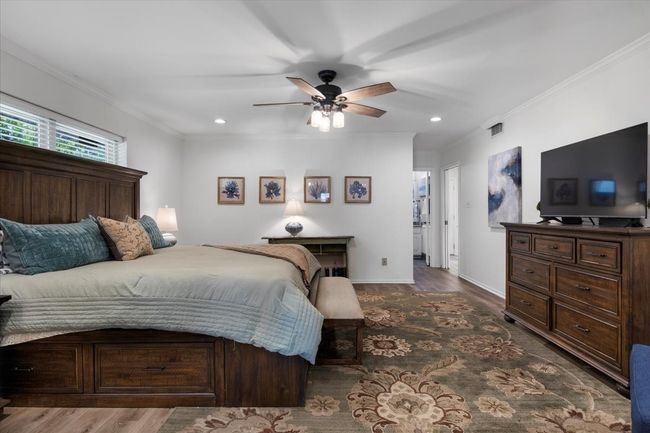 Bedroom with wood finished floors, recessed lighting, and ornamental molding | Image 16