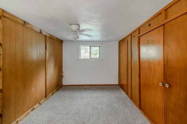 Bedroom with a textured ceiling, light carpet, and ceiling fan | Image 51
