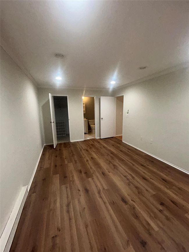 Finished below grade area featuring wood finished floors and baseboards | Image 11