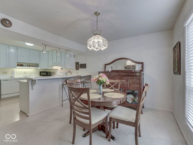 Nice size dining area with view of kitchen including a spacious breakfast bar | Image 12