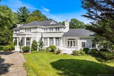 Front of the house with circular driveway, separate entrance to study, the 3 car garage is to the far right, back of the house | Image 2