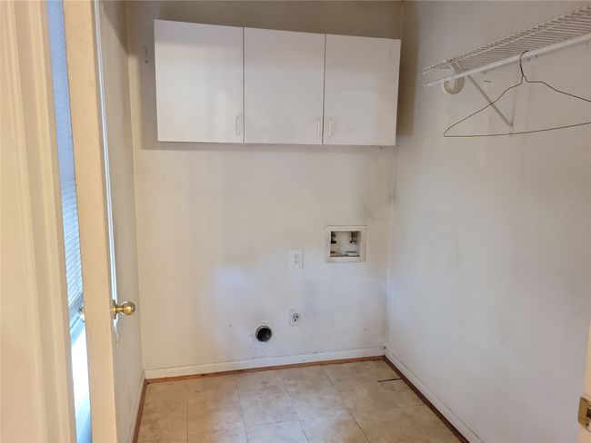 Clothes washing area featuring cabinet space, washer hookup, baseboards, and hookup for an electric dryer | Image 8