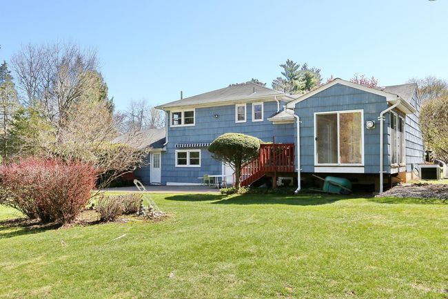 Rear view of property featuring a lawn and a wooden deck | Image 33