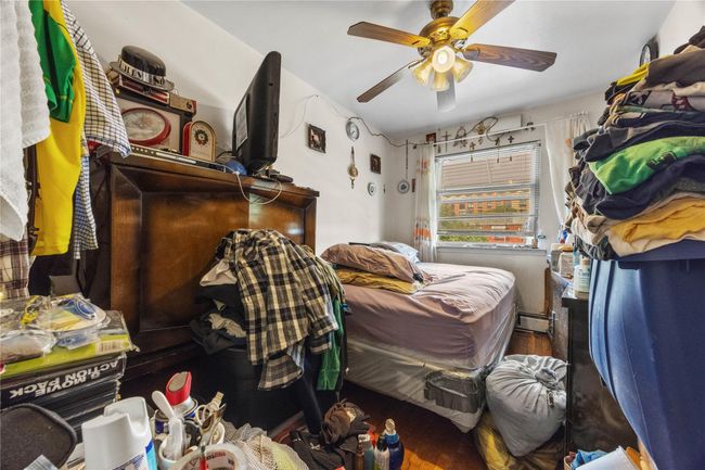 Bedroom with ceiling fan and wood finished floors | Image 6