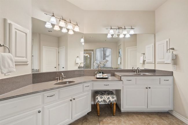 The primary bath includes a double vanity for added convenience, a relaxing soaking tub, and a walk-in shower. | Image 26