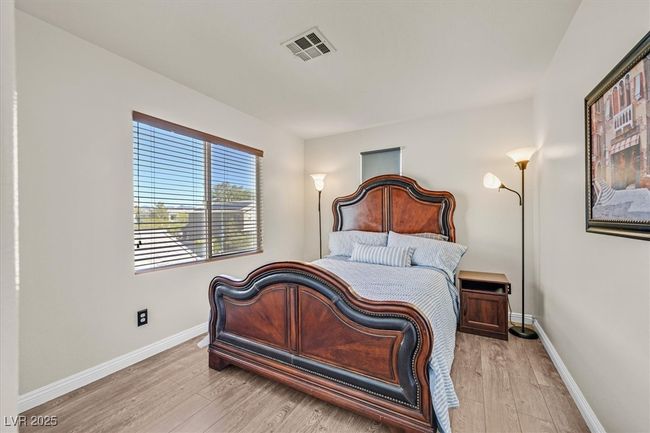 Bedroom featuring light wood finished floors, visible vents, and baseboards | Image 21