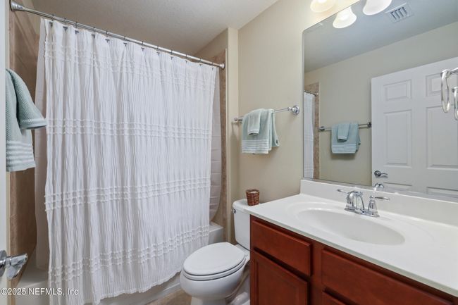 Well-appointed guest bathroom conveniently located near secondary bedrooms and living areas. | Image 16