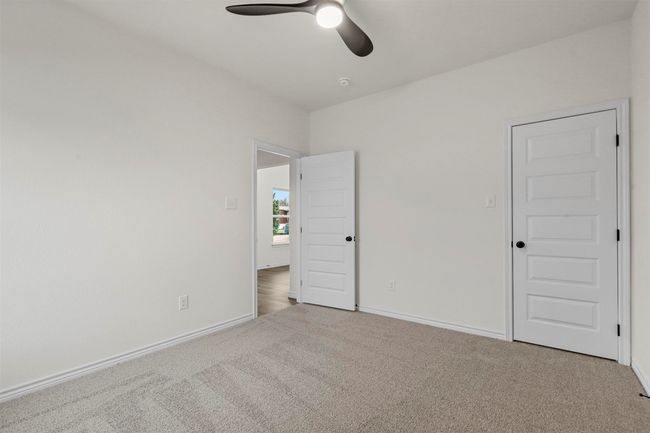 Unfurnished bedroom featuring ceiling fan and light colored carpet | Image 30