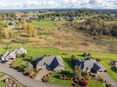 This aerial shot is giving major ‘wow’ vibes! The spacious lot, those stunning wetlands, and a coy Mt. Rainier hidden behind the clouds. Plus, with a hiking trail right at your doorstep, it’s like having a personal invitation to nature's best party. Get ready to explore! | Image 3