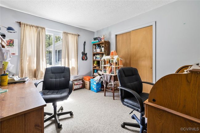 Carpeted office space featuring a textured ceiling | Image 18