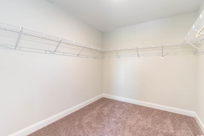Spacious closet with carpet floors | Image 20