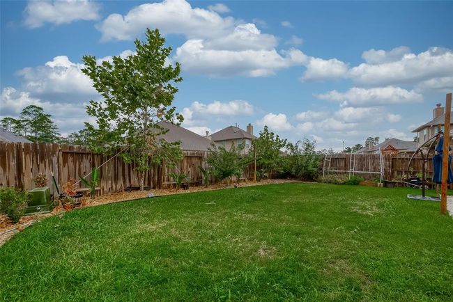 Yard is fully fenced with nice landscaping | Image 40