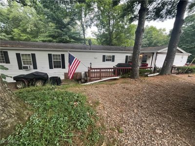 Manufactured / mobile home featuring cooling unit and a deck | Image 1